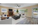 Bright living room featuring a fireplace, lots of natural light, and stylish furniture at 3303 W Ballast Point Blvd, Tampa, FL 33611
