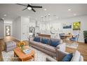 Sunlit living room showcases stylish furnishings, an open floor plan, and a seamless transition to the dining area at 331 Archimedes St, Dunedin, FL 34698