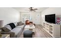Bright living room featuring neutral decor, stylish furniture, and wood-look flooring at 3343 Fox Hunt Dr, Palm Harbor, FL 34683