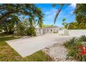Sprawling single story home featuring a large driveway and lush landscaping at 3801 Dr Martin Luther King Jr N St, St Petersburg, FL 33703