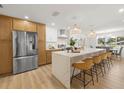 Bright, updated kitchen featuring a large island with seating, stainless steel appliances, and pendant lighting at 3801 Dr Martin Luther King Jr N St, St Petersburg, FL 33703
