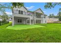 Expansive backyard with a multi-level patio, balconies, and well-kept lawn, perfect for outdoor living at 4522 Majestic Hills Loop, Brooksville, FL 34601