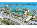Stunning aerial view of waterfront condos offering gorgeous city and ocean views with community pool and tennis courts at 4700 Cove Cir # 301, St Petersburg, FL 33708