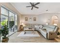 Inviting living room with tile floors, a large sectional sofa, and sliding glass doors to the lanai at 5027 Cross Pointe Dr, Oldsmar, FL 34677