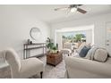 Bright and inviting living room showcasing neutral decor, ceiling fan, and large window at 5302 44Th N Ave, St Petersburg, FL 33710