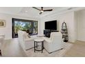 Cozy living room with a sliding glass door to outdoor patio, a ceiling fan, and lots of natural light at 5410 Morey Farms Loop, Palmetto, FL 34221