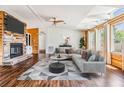 Bright living room featuring hardwood floors, a stone fireplace, skylights, and comfortable seating at 6036 110Th N Ave, Pinellas Park, FL 33782