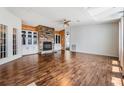 Spacious living room with hardwood floors, stone fireplace, and built-in cabinets at 6036 110Th N Ave, Pinellas Park, FL 33782
