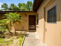 Inviting front door with a storm door, complemented by a lush landscaping at 6201 Amaretto Ln # 6201, Tampa, FL 33634