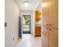Hallway and entry featuring tile floors with a view of the front yard and cabinet storage at 6201 Amaretto Ln # 6201, Tampa, FL 33634