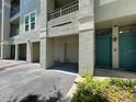 Exterior shot of condo featuring balcony, garage and teal front door at 622 Seascape Way, Tampa, FL 33602