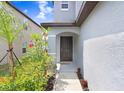 The home features a inviting front door and landscaping at 6384 Ten Acre Ct, Zephyrhills, FL 33541