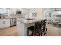 Modern kitchen with granite counters, stainless steel appliances, and a breakfast bar with seating at 656 40Th Ne Ave, St Petersburg, FL 33703