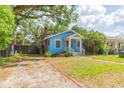 Quaint blue home with well-maintained landscaping, driveway and a cozy, inviting curb appeal at 904 E Patterson St, Tampa, FL 33604