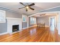 Open living room featuring hardwood floors, a brick fireplace, neutral paint, and an archway at 904 E Patterson St, Tampa, FL 33604