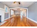 Spacious living room with hardwood floors, neutral paint, fireplace, archway, and dining table at 904 E Patterson St, Tampa, FL 33604