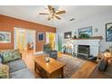 Cozy living room featuring hardwood floors, a decorative fireplace, and a comfortable seating area for relaxation at 916 E Broad St, Tampa, FL 33604