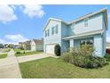 Charming two-story house with a blue exterior, featuring a neat lawn and driveway at 3509 San Moise St, Plant City, FL 33567