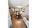 Open dining room with wood floors, seamlessly connecting to the kitchen area at 10411 Summerview Cir, Riverview, FL 33578