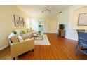 Bright living room features wood floors, comfortable seating, and sliding doors leading to the outside at 10716 Ashford Oaks Dr, Tampa, FL 33625