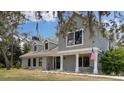 Inviting two-story home featuring a classic design and mature landscaping at 11207 Donneymoor Dr, Riverview, FL 33569