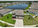 Beautiful aerial view of a two-story home with a pond view and lush green lawn at 11924 Brighton Knoll Loop, Riverview, FL 33579