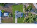 Aerial view showcases a well-maintained property, neatly landscaped with a symmetrical layout and neutral roof at 12486 Gulfstream Blvd, Port Charlotte, FL 33981