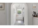 Bright foyer featuring a bench seat, nautical decor, and ample natural light through the front door at 13035 91St Ave, Seminole, FL 33776