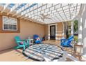 Cozy front porch with stylish seating, decorative compass painting, ceiling fan and pergola at 13035 91St Ave, Seminole, FL 33776