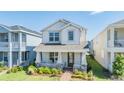 Charming two-story home with a welcoming front porch, landscaped garden and a brick walkway at 13614 Stevenson Ln, Odessa, FL 33556