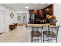 Open kitchen with stainless steel appliances, granite countertops, and an eat-in bar area at 173 21St Se Ter, Largo, FL 33771