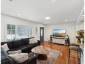 Inviting living room featuring a comfortable dark sofa, wood floors, and ample natural light at 173 21St Se Ter, Largo, FL 33771