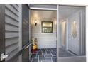 Inviting entryway with tiled floor, screened door, and stylish front door at 2033 Arbor Dr, Clearwater, FL 33760