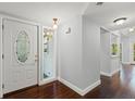 Bright foyer featuring hardwood floors and a white front door with decorative glass at 2033 Arbor Dr, Clearwater, FL 33760