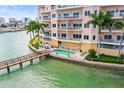 Condo exterior showing private pool with bridge access to the building and balconies overlooking waterfront at 205 Brightwater Dr # 101, Clearwater Beach, FL 33767