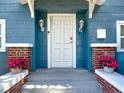 Inviting front door with decorative lanterns and a charming entryway, enhancing the home's curb appeal at 207 W Chelsea St, Tampa, FL 33603