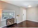 Cozy living room with dark wood floors, a large window for natural light and stylish cabinet at 207 W Chelsea St, Tampa, FL 33603