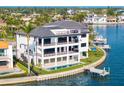 Stunning waterfront home with multiple balconies, a private pool, and a boat dock, offering luxurious coastal living at 2087 Michigan Ne Ave, St Petersburg, FL 33703