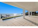 Expansive waterfront patio featuring a zero-edge pool, covered seating area, and a private dock at 2087 Michigan Ne Ave, St Petersburg, FL 33703