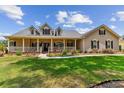 Beautiful home featuring a welcoming front porch, classic architectural details, and well-maintained landscaping at 2202 Colewood Ln, Dover, FL 33527
