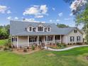 Lovely one-story home with a charming front porch, well-manicured lawn, and beautiful landscaping at 2202 Colewood Ln, Dover, FL 33527