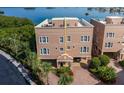 Elegant multi-story condo featuring a rooftop terrace, covered parking, and lush landscaping at 2750 Reserve Ct # 101, Dunedin, FL 34698