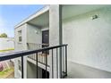 Second story condo entrance with black metal railing, door number 203 at 2840 Somerset Park Dr # 203, Tampa, FL 33613