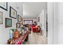 Hallway with white tile flooring leading to the living room with bright decor and furnishings at 2840 Somerset Park Dr # 203, Tampa, FL 33613