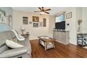 Inviting living room featuring wood floors, stylish decor, and a comfortable sofa at 30140 Barnaby Ln, Wesley Chapel, FL 33543