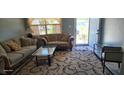 Comfortable living room with neutral tones, plush sofas, and a glass coffee table at 3026 19Th Sw Pl, Largo, FL 33774