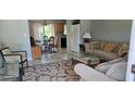 Inviting living room with tile floors, comfortable seating, and an adjacent dining area at 3026 19Th Sw Pl, Largo, FL 33774