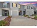 Contemporary townhome with well-maintained landscaping, neutral paint, and a private garage at 32965 Kaloko Rd, Wesley Chapel, FL 33543