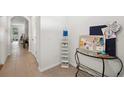 Bright hallway with modern decor, featuring stylish organizers and neutral tones at 32965 Kaloko Rd, Wesley Chapel, FL 33543