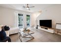 Bright and airy living room with sliding glass doors, modern furnishings, and neutral colors at 32965 Kaloko Rd, Wesley Chapel, FL 33543